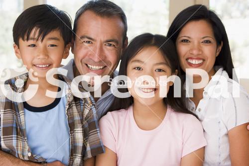 Family In Living Room Smiling